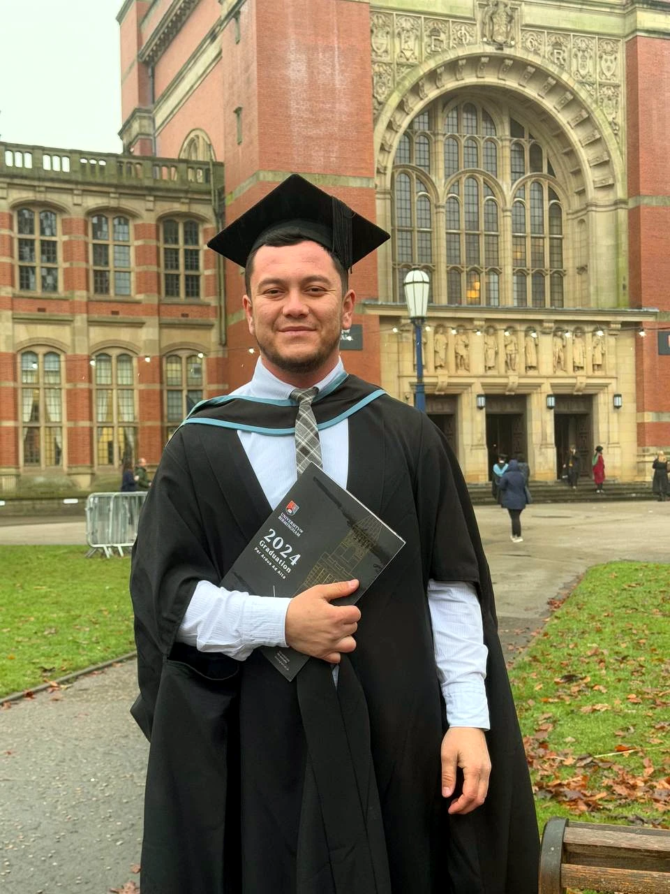 Murod Kamilov in graduation attire at the University of Birmingham